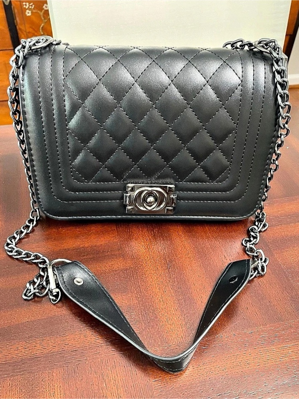 Black quilted faux leather crossbody hand bag in black